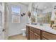 Bright bathroom with a single sink vanity, decorative accents, and window light at 9343 W Atlantis Way, Tolleson, AZ 85353