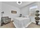 Cozy bedroom with a comfortable bed, patterned armchair, and plenty of natural light at 9343 W Atlantis Way, Tolleson, AZ 85353