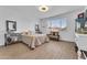 Comfortable bedroom featuring a quilted bed, wood-look floors, and decorative furnishings at 9343 W Atlantis Way, Tolleson, AZ 85353