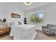 Charming bedroom with neutral tones, a plush bed, and large window view at 9343 W Atlantis Way, Tolleson, AZ 85353