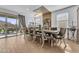 Bright dining area with large windows, an elegant chandelier, and comfortable seating, perfect for gatherings and meals at 9343 W Atlantis Way, Tolleson, AZ 85353