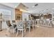 Elegant dining room featuring a contemporary chandelier, a large table, and access to the kitchen and other living areas at 9343 W Atlantis Way, Tolleson, AZ 85353