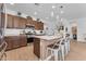 Modern kitchen with quartz countertops, stainless steel appliances, and an island with seating, perfect for entertaining at 9343 W Atlantis Way, Tolleson, AZ 85353