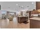 Bright open-concept living space featuring a kitchen island, stainless appliances, and seamless access to the outdoors at 9343 W Atlantis Way, Tolleson, AZ 85353