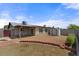 Spacious backyard with a patio area, brick accents, privacy walls, and plenty of room for outdoor activities at 9625 W Mountain View Rd # A, Peoria, AZ 85345