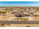 Aerial view of home, showcasing lush landscaping, desert flora, and large circular driveway at 11119 W Mountain View Rd, Sun City, AZ 85351