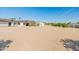 Spacious backyard featuring a gravel landscape, multiple buildings, and lush greenery, perfect for outdoor activities at 11119 W Mountain View Rd, Sun City, AZ 85351
