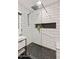 Bathroom with modern walk-in shower, tile backsplash, hexagon-tiled floors, and modern sink at 11119 W Mountain View Rd, Sun City, AZ 85351