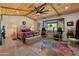 Stylized bedroom with a large bed, patterned rug, and wood-paneled ceilings at 11119 W Mountain View Rd, Sun City, AZ 85351