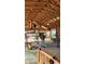 Image showing interior construction with wooden framing, insulation, and workers on scaffolding at 11119 W Mountain View Rd, Sun City, AZ 85351