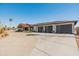 Stunning exterior view showcasing the home's architectural details, multiple garages, and desert landscaping at 11119 W Mountain View Rd, Sun City, AZ 85351
