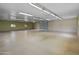 Spacious garage with concrete floors, providing ample space for vehicles and storage at 11119 W Mountain View Rd, Sun City, AZ 85351