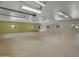 Expansive garage featuring windows and concrete floors, offering ample space and natural light at 11119 W Mountain View Rd, Sun City, AZ 85351