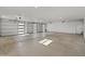 A very large and well-lit garage with three garage doors with horizontal windows at 11119 W Mountain View Rd, Sun City, AZ 85351