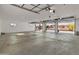 An oversized three-car garage featuring ample windows and three access doors at 11119 W Mountain View Rd, Sun City, AZ 85351