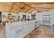 Bright kitchen featuring a large island, sleek white cabinets, modern appliances and seamlessly flowing open floorplan at 11119 W Mountain View Rd, Sun City, AZ 85351