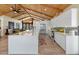 Bright kitchen featuring a large island, sleek white cabinets, modern appliances and seamlessly flowing open floorplan at 11119 W Mountain View Rd, Sun City, AZ 85351