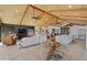 Open-concept living space featuring wood ceilings, tile flooring, cozy seating, and abundant natural light at 11119 W Mountain View Rd, Sun City, AZ 85351