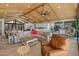 Open-concept living space showcasing wood ceiling, tile floor, comfortable furniture, and backyard access at 11119 W Mountain View Rd, Sun City, AZ 85351