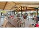 Spacious living room with wood ceiling, tile floor, comfortable seating, and large windows with views at 11119 W Mountain View Rd, Sun City, AZ 85351
