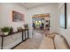 An inviting entryway and view into a living space with wood-beam ceilings and neutral-toned walls at 11119 W Mountain View Rd, Sun City, AZ 85351