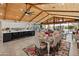 Spacious open-concept living space featuring wood ceiling, tile flooring, and seamless indoor-outdoor living at 11119 W Mountain View Rd, Sun City, AZ 85351