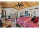 Spacious main bedroom with wooden ceiling, ceiling fan, colorful rug, and plenty of natural light at 11119 W Mountain View Rd, Sun City, AZ 85351