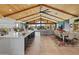 Spacious open floorplan seamlessly flowing from the kitchen to the living and dining areas with vaulted wooden ceilings at 11119 W Mountain View Rd, Sun City, AZ 85351