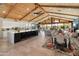Spacious open floorplan seamlessly flowing from the kitchen to the living and dining areas with vaulted wooden ceilings at 11119 W Mountain View Rd, Sun City, AZ 85351
