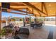 Outdoor patio with lounge seating and dining table under a wooden pergola at 11119 W Mountain View Rd, Sun City, AZ 85351