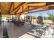 Outdoor patio with lounge seating and dining table under a wooden pergola at 11119 W Mountain View Rd, Sun City, AZ 85351