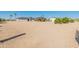 Expansive property with multiple buildings, mature landscaping, and a vast gravel area, offering privacy and space at 11119 W Mountain View Rd, Sun City, AZ 85351