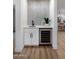 Stylish bar area with white cabinetry, beverage cooler, designer tile backsplash, and modern fixtures at 14639 N 55Th Pl, Scottsdale, AZ 85254