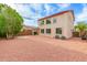 Large backyard with space for entertaining and a two-story home with tan siding at 16215 W Durango St, Goodyear, AZ 85338