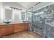 Modern bathroom with a glass shower, and vessel sinks at 16215 W Durango St, Goodyear, AZ 85338
