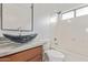 Bathroom featuring a vessel sink with modern fixtures and a bathtub at 16215 W Durango St, Goodyear, AZ 85338