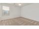 Bright bedroom with neutral carpet, ceiling fan, and natural light from the window at 16215 W Durango St, Goodyear, AZ 85338