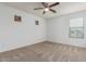 Bright bedroom featuring a ceiling fan, neutral carpeting, and a window providing natural light at 16215 W Durango St, Goodyear, AZ 85338