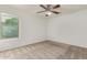 Bedroom with neutral carpet, ceiling fan, and a window with a view at 16215 W Durango St, Goodyear, AZ 85338