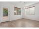 Bright dining room with laminate wood floors, neutral paint, and large windows at 16215 W Durango St, Goodyear, AZ 85338