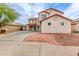 View of the front yard with decorative rock and spacious driveway at 16215 W Durango St, Goodyear, AZ 85338