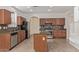Gourmet kitchen with an island, granite counters, stainless steel appliances, and wood cabinetry at 16215 W Durango St, Goodyear, AZ 85338