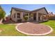 This home features a well-maintained backyard with a charming patio area and lush green lawn at 16768 W Nottingham Way, Surprise, AZ 85374