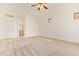 Neutral bedroom with carpet flooring and a glimpse of a hall and closet at 16768 W Nottingham Way, Surprise, AZ 85374