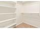 Walk-in closet featuring built-in shelving and carpeted floor at 16768 W Nottingham Way, Surprise, AZ 85374
