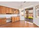 Bright dining area with wood floors, sliding glass doors to the patio, and wooden cabinets at 16768 W Nottingham Way, Surprise, AZ 85374
