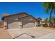 Attractive single-story home with a desert landscaped front yard, and a three-car garage at 16768 W Nottingham Way, Surprise, AZ 85374