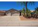 Charming single-story home features a three-car garage and desert landscaping at 16768 W Nottingham Way, Surprise, AZ 85374