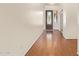 Inviting hallway with hardwood floors and a decorative front door at 16768 W Nottingham Way, Surprise, AZ 85374