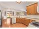 Well-lit kitchen featuring wood cabinetry, counter space, and a view of the backyard at 16768 W Nottingham Way, Surprise, AZ 85374
